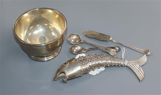 A Mexican white metal reticulated fish, a silver sugar bowl, two silver condiment spoons and a silver butter knife.